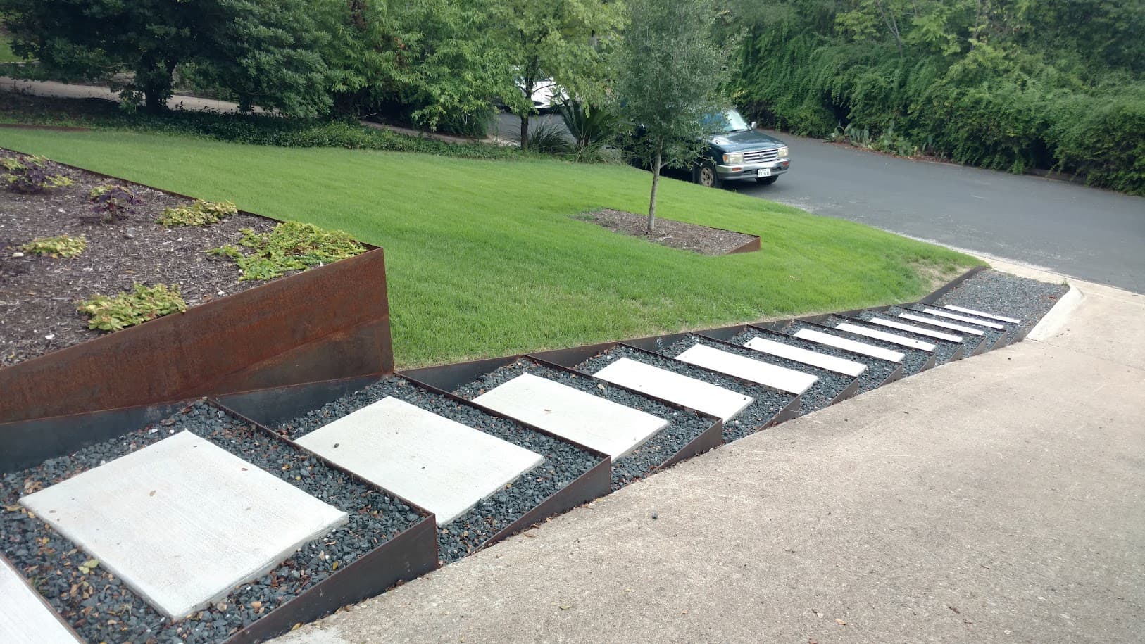 Kellison project, steel fencing with stone accents and native planting border