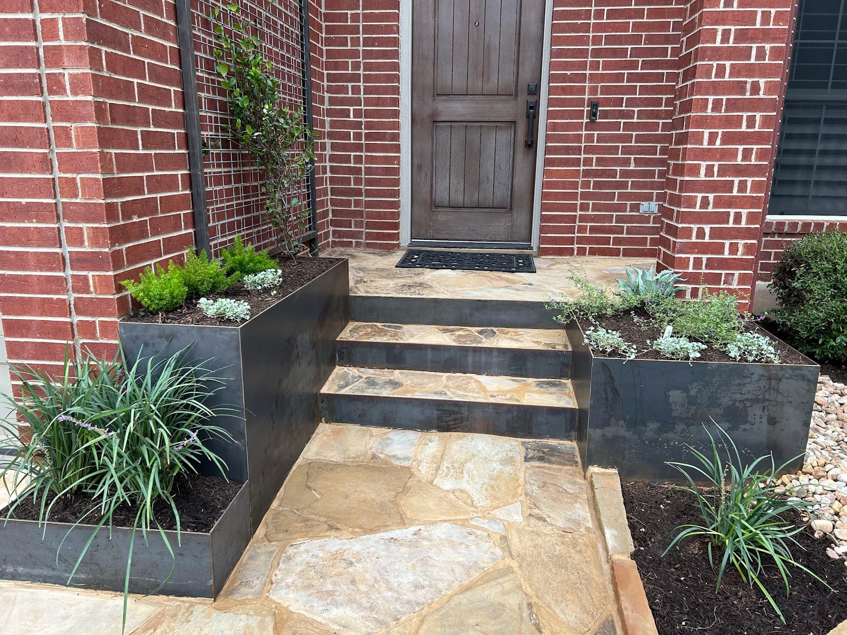 Stone and steel landscape feature, combining Texas limestone with Cor-Ten steel for a bold structural statement