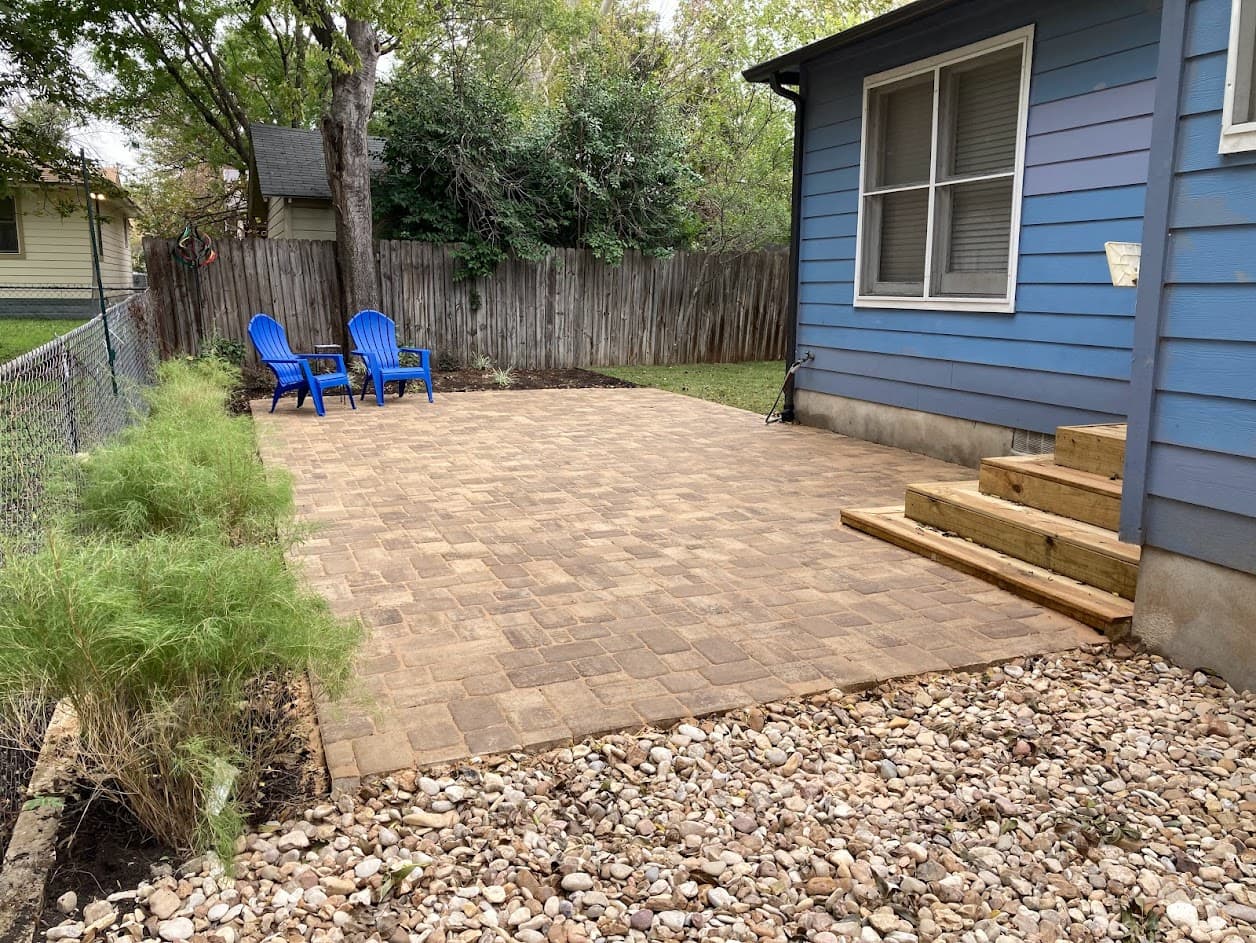 Classic Cambridge paver patio installation with clean geometric patterns and integrated planting beds