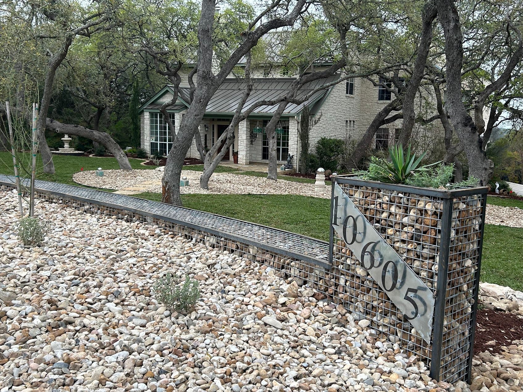 Gabion flower bed with integrated address marker, functional and sculptural landscape feature